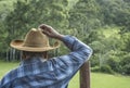 Ibitipoca, Lima Duarte, Minas Gerais, Brazil - March 13, 2016: Cowboy with traditional hat leaning on wood fence pole, looking to