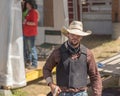 Cowboy walks into arena to compete in Wild Horse Race at stampede