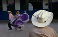 Cowboy watching hispanic dancers Royalty Free Stock Photo