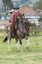 Cowboy wearing furry chaps and wool poncho in Ecuador