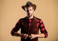 Cowboy wearing hat. Western life. Man unshaven cowboy beige background. Unshaven guy in cowboy hat. Handsome bearded