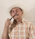 Cowboy in white hat with Pipe