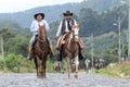 Cowboys arriving to a rural rodeo