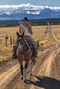 Cowboys on Cattle Drive on long dirt road to San Juan Mountains