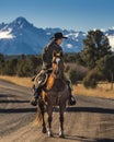 Cowboys on Cattle Drive on long dirt road to San Juan Mountains