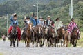 Cowboys in the Ecuadorian Andes riding on a country road