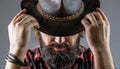 Cowboys in hat. Handsome bearded macho. Man unshaven cowboys. American cowboy. Leather Cowboy Hat. Portrait of young man Royalty Free Stock Photo