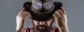 Cowboys in hat. Handsome bearded macho. Man unshaven cowboys. American cowboy. Leather Cowboy Hat. Portrait of young man Royalty Free Stock Photo