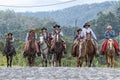 Cowboys on horse back on a country road in Ecuador