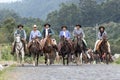 Cowboys riding in group outdoors