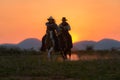 Cowboys are riding horses silhouette