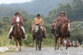 Cowboys in traditional wear riding in the Andes of Ecuador Royalty Free Stock Photo