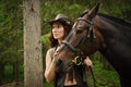 Cowgirl with brown horse Royalty Free Stock Photo