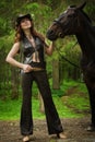 Cowgirl with brown horse Royalty Free Stock Photo