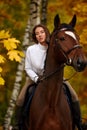 Cowgirl in a cowboy hat rides a horse on the background of the forest. Motion blur effect. Royalty Free Stock Photo