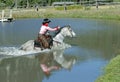 Cowgirl Crossing Pond with Reflection Royalty Free Stock Photo