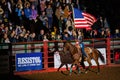 Cowgirl holding America flag in the Stockyards Championship Rodeo