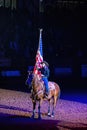 Cowgirl holding America flag in the Stockyards Championship Rodeo