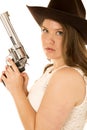 Cowgirl holding a big revolver with a very serious expression Royalty Free Stock Photo