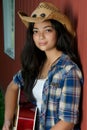 Cowgirl playing guitar by the barn Royalty Free Stock Photo