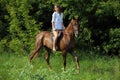 Cowgirl ride horse in woods