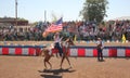 Cowgirl riding with American Flag