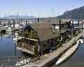 Cowichan Bay Marina with a float home, a large row boat and boats in the background