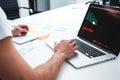 Coworker man using laptop and printed blueprint in modern office Royalty Free Stock Photo