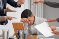 Coworkers bullying their colleague at workplace in office, closeup Royalty Free Stock Photo