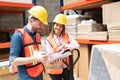 Coworkers Checking List On Clipboard At Factory