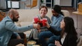 Coworkers clinking cups and bottles to enjoy leisure after work