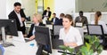 Coworkers engaged in open plan office