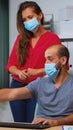 Coworkers with face masks working Royalty Free Stock Photo