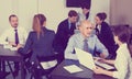 Coworkers with laptops having a productive day in office Royalty Free Stock Photo