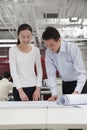 Coworkers smiling analyzing architecture project in the office Royalty Free Stock Photo