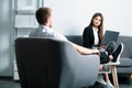 Coworkers talking. Couple of freelancers discussing about work in an office. Two young business workers working together Royalty Free Stock Photo