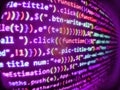 Coworkers team in modern office. Software abstract background. Screen of green colored syntax of source code script with defocus. Royalty Free Stock Photo