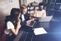 Coworkers team at work. Group of young business people in trendy casual wear working together in creative office Royalty Free Stock Photo