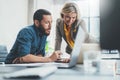 Coworkers team at work. Group of young business people in trendy casual wear working together in creative office Royalty Free Stock Photo