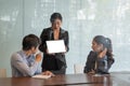 Coworkers team at work. Group of young business people in trendy working together in creative office with digital teblet Royalty Free Stock Photo