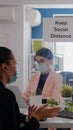 Coworkers wearing medical face masks to prevent infection with coronavirus