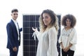 Coworkers working in the office showing a solar panel