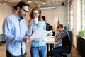 Coworking colleagues having conversation at workplace