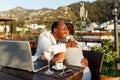 Coworking and freelance concept success hugs .Mixed race middle age black skin man and woman working together on laptop