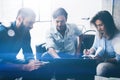 Coworking process in a sunny office.Young people working on computer and using mobile devices.Business team sitting on Royalty Free Stock Photo