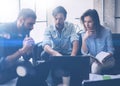 Coworking process in a sunny office.Young people working on computer and using mobile devices.Business team sitting on Royalty Free Stock Photo