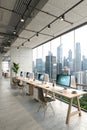 Coworking space with PCs and panoramic window view Royalty Free Stock Photo