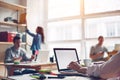 Coworking station. Modern business loft and millenials working together. Blank laptop typing Royalty Free Stock Photo