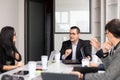 coworking team discussing project in a meeting room, mixed Hispanic people group at the office, talking seriously at the office, Royalty Free Stock Photo