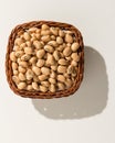 Cowpea legume. Wicker basket with grains. Top view, hard light.
